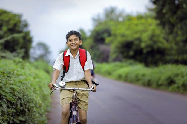 Schoolchild riding a bicycle for the Gadchiroli bicycle project