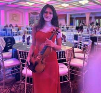 Sarah performing violin at a Valentine's Day fundraiser