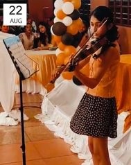 Sarah performing violin at a Los Angeles fundraiser