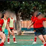 Girls playing soccer with support from S&S Charity