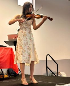 Sarah performing violin at the Parents Day fundraiser